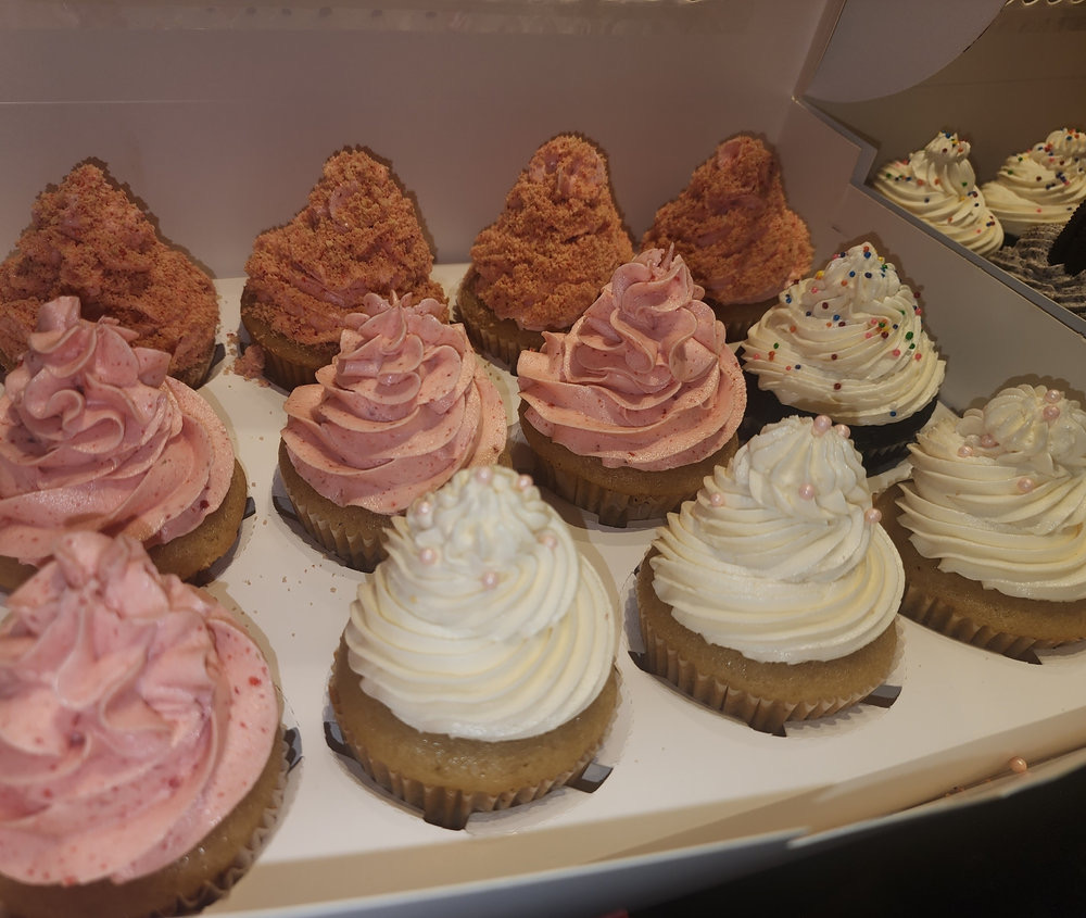 Box of assorted vegan cupcakes with strawberry, vanilla pearl and strawberry crumb toppings